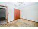 Bedroom with a closet, ceiling fan, and an open doorway at 3990 Se 20Th Ct, Ocala, FL 34480