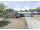 Charming single-story home with a well-manicured lawn and a long driveway leading to an attached garage at 3990 Se 20Th Ct, Ocala, FL 34480