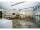 Spacious garage featuring overhead lighting, shelving, a window, and an automatic door opener at 3990 Se 20Th Ct, Ocala, FL 34480