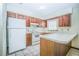 Cozy kitchen with white appliances and vintage wood cabinets at 3990 Se 20Th Ct, Ocala, FL 34480