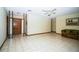 Spacious living room with tiled floors, ceiling fan, and a decorative entry way at 3990 Se 20Th Ct, Ocala, FL 34480