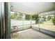 Open-air screened porch with backyard view at 3990 Se 20Th Ct, Ocala, FL 34480