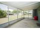 View of screened porch with concrete floor and backyard beyond at 3990 Se 20Th Ct, Ocala, FL 34480