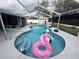 Serene screened-in pool offers a refreshing escape, complete with fun floaties and tiled details at 4413 Sw 145Th Place Rd, Ocala, FL 34473
