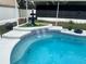 Close-up of the sparkling pool area featuring a tiered fountain and decorative tile at 4413 Sw 145Th Place Rd, Ocala, FL 34473