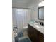 Well-lit bathroom features a granite countertop, and a shower with a colorful curtain at 8533 Sw 93Rd Pl # A, Ocala, FL 34481