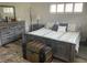 Bedroom featuring wood-look floors, comfortable bed with decorative pillows, and soft natural light at 8533 Sw 93Rd Pl # A, Ocala, FL 34481