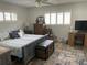 Bedroom featuring a comfortable bed with decorative pillows, wood-look floors, and natural light at 8533 Sw 93Rd Pl # A, Ocala, FL 34481