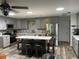 Modern kitchen with light grey cabinets, stainless steel appliances, and center island with bar seating at 8533 Sw 93Rd Pl # A, Ocala, FL 34481