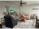 A cozy living room with neutral walls, a ceiling fan, and plenty of seating, perfect for relaxation at 8533 Sw 93Rd Pl # A, Ocala, FL 34481