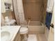 Bathroom featuring a bathtub with accessibility handle, a toilet, and a sink at 8665 Sw 94Th St # C, Ocala, FL 34481