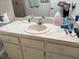 Bathroom featuring a single sink vanity with a white marbled countertop and cabinets at 8665 Sw 94Th St # C, Ocala, FL 34481