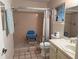 Bathroom featuring a tiled shower with a seat, toilet, and single vanity at 8665 Sw 94Th St # C, Ocala, FL 34481