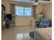Bedroom with a full bookshelf, a large window and a chair at 8665 Sw 94Th St # C, Ocala, FL 34481