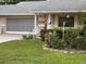 Charming single-story home featuring a well-manicured lawn and an attached two-car garage at 8665 Sw 94Th St # C, Ocala, FL 34481