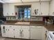 A kitchen featuring white cabinets, and a window above the sink at 8665 Sw 94Th St # C, Ocala, FL 34481