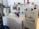 Bright laundry area with washer, dryer, utility sink and overhead storage at 8665 Sw 94Th St # C, Ocala, FL 34481
