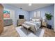 Light-filled bedroom features a neutral palette, soft blue walls, and comfortable furniture at 9000 Sw 204Th Cir, Dunnellon, FL 34431