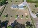 Aerial view of home with spacious grounds including a big yard, and long driveway at 11395 Se 108Th Terrace Rd, Belleview, FL 34420
