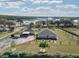 Beautiful aerial view of the property with lush landscaping and a picturesque lake in the background at 11395 Se 108Th Terrace Rd, Belleview, FL 34420