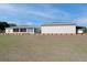 Expansive backyard featuring an enclosed porch, green lawn, and well-maintained landscaping, perfect for outdoor enjoyment at 11395 Se 108Th Terrace Rd, Belleview, FL 34420