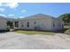 Spacious backyard, partially covered in gravel, featuring an exterior patio and well-maintained lawn space at 11395 Se 108Th Terrace Rd, Belleview, FL 34420