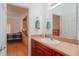 Bathroom featuring a wooden vanity with a sink and a view into the bedroom at 11395 Se 108Th Terrace Rd, Belleview, FL 34420
