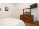 Spacious bedroom featuring a large dresser with mirror and ample closet space, perfect for storage at 11395 Se 108Th Terrace Rd, Belleview, FL 34420