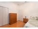 Bright bedroom with wooden floors, and matching dresser and nightstand for a cohesive design at 11395 Se 108Th Terrace Rd, Belleview, FL 34420