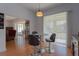 Dining room features laminate floors, contemporary light fixture and patio access at 11395 Se 108Th Terrace Rd, Belleview, FL 34420
