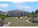 Exterior elevation of the home showing the yard and backyard trees at 11395 Se 108Th Terrace Rd, Belleview, FL 34420