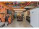 Ample garage space with lawn equipment, workbench, and overhead storage for sports equipment at 11395 Se 108Th Terrace Rd, Belleview, FL 34420