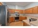 Functional kitchen featuring stainless steel appliances and warm wood cabinetry at 11395 Se 108Th Terrace Rd, Belleview, FL 34420