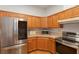 Well-lit kitchen featuring stainless steel appliances and wood cabinets at 11395 Se 108Th Terrace Rd, Belleview, FL 34420