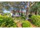 Lush backyard with mature oak and palm trees with grass and home's rear exterior at 11427 Sw 82Nd Ave, Ocala, FL 34481