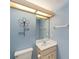 Bathroom features a sink vanity and decorative flower wall decor at 11427 Sw 82Nd Ave, Ocala, FL 34481