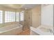 Bathroom with marble tub, glass block window and walk-in shower at 11427 Sw 82Nd Ave, Ocala, FL 34481