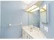 Bathroom featuring a single sink vanity, a large mirror, and a towel rack at 11427 Sw 82Nd Ave, Ocala, FL 34481
