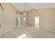 Large bedroom with neutral carpet, ceiling fan, and two entryways at 11427 Sw 82Nd Ave, Ocala, FL 34481