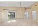 Bright bedroom with neutral carpet, ceiling fan, and sliding glass doors to the lanai at 11427 Sw 82Nd Ave, Ocala, FL 34481