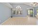 Dining area featuring tile flooring, a sliding glass door, and a chandelier at 11427 Sw 82Nd Ave, Ocala, FL 34481