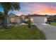 Charming single-story home with a well-manicured lawn at dusk at 11427 Sw 82Nd Ave, Ocala, FL 34481
