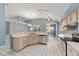 Open kitchen with tiled floor, breakfast bar, and stainless steel dishwasher and sink at 11427 Sw 82Nd Ave, Ocala, FL 34481