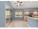 Bright eat-in kitchen with sliding glass doors, neutral cabinets, and tile flooring at 11427 Sw 82Nd Ave, Ocala, FL 34481