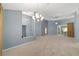 Open living room with light blue walls, carpet, and access to other areas of the home at 11427 Sw 82Nd Ave, Ocala, FL 34481