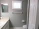 Well-lit bathroom with a single sink vanity and a large framed mirror at 11495 Sw 138Th Ln, Dunnellon, FL 34432