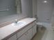 Well-lit bathroom with a clean vanity, neutral tile floor, and a shower-tub combo at 11495 Sw 138Th Ln, Dunnellon, FL 34432