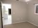 Bright, carpeted bedroom with a window and an open doorway to another room at 11495 Sw 138Th Ln, Dunnellon, FL 34432