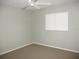 Neutral colored bedroom with carpet, ceiling fan and plantation shutters at 11495 Sw 138Th Ln, Dunnellon, FL 34432