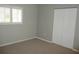 Bedroom with a window and closet doors at 11495 Sw 138Th Ln, Dunnellon, FL 34432
